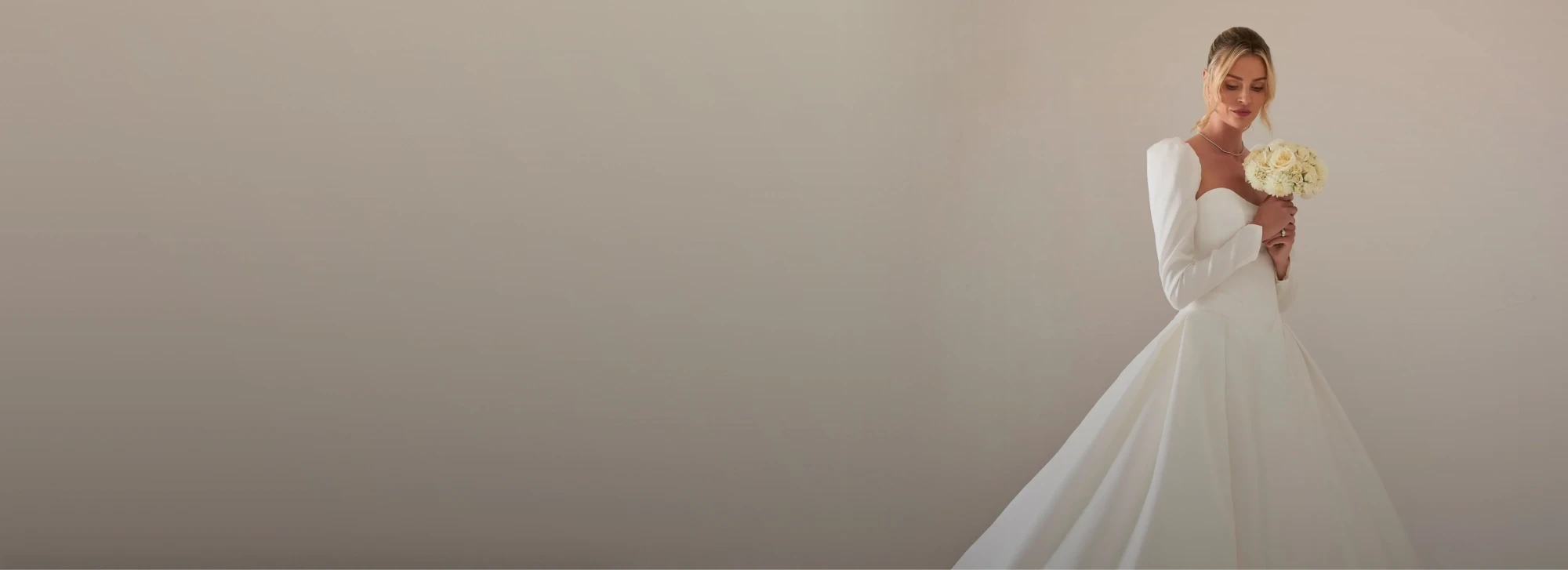 Model wearing a white gown by Karin Shemesh