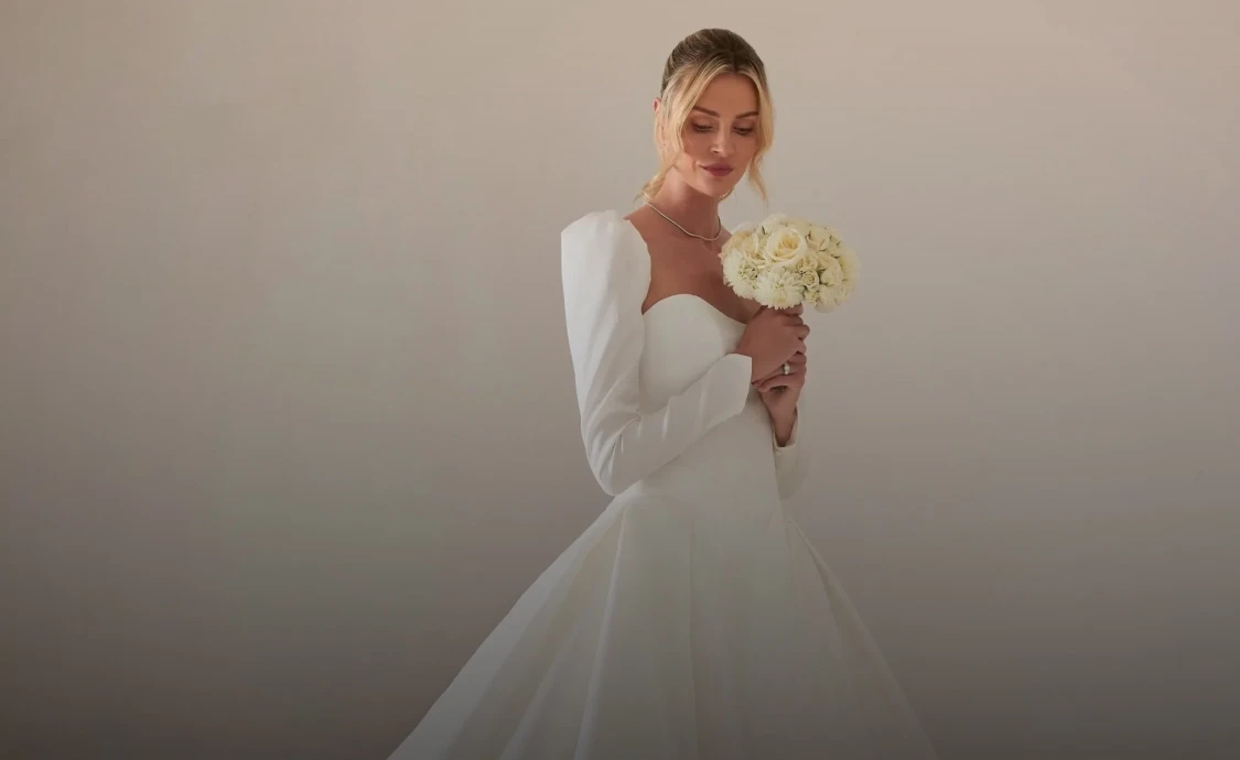 Model wearing a white gown by Karin Shemesh. Mobile image