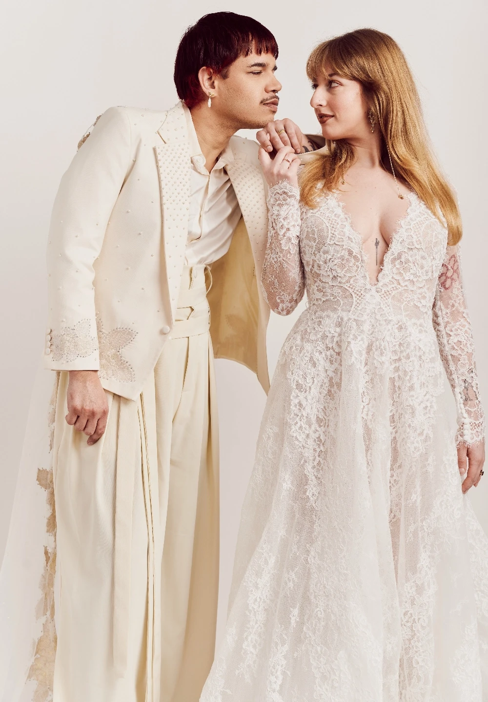 Сouple wearing a white gown and a white suit