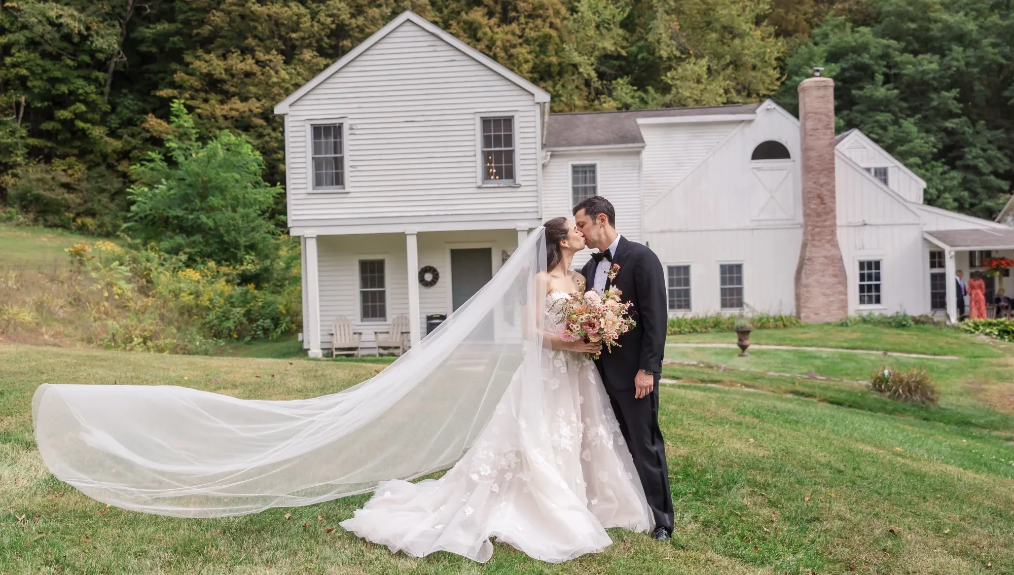 Сouple wearing a white gown and a black suit