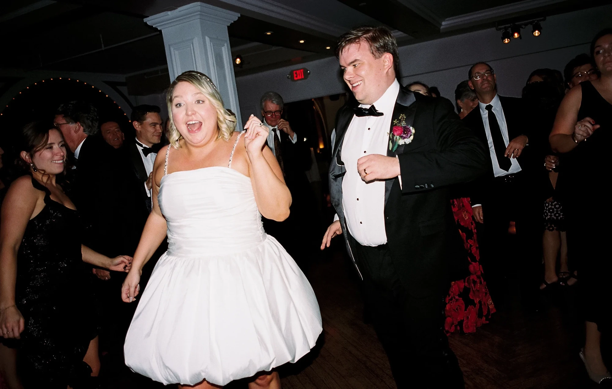 Сouple wearing a white gown and a black suit
