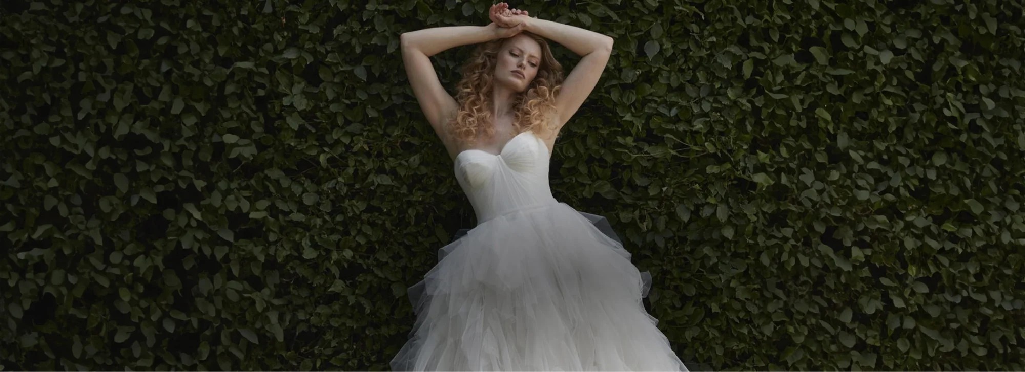 Model wearing a white gown by Karin Shemesh